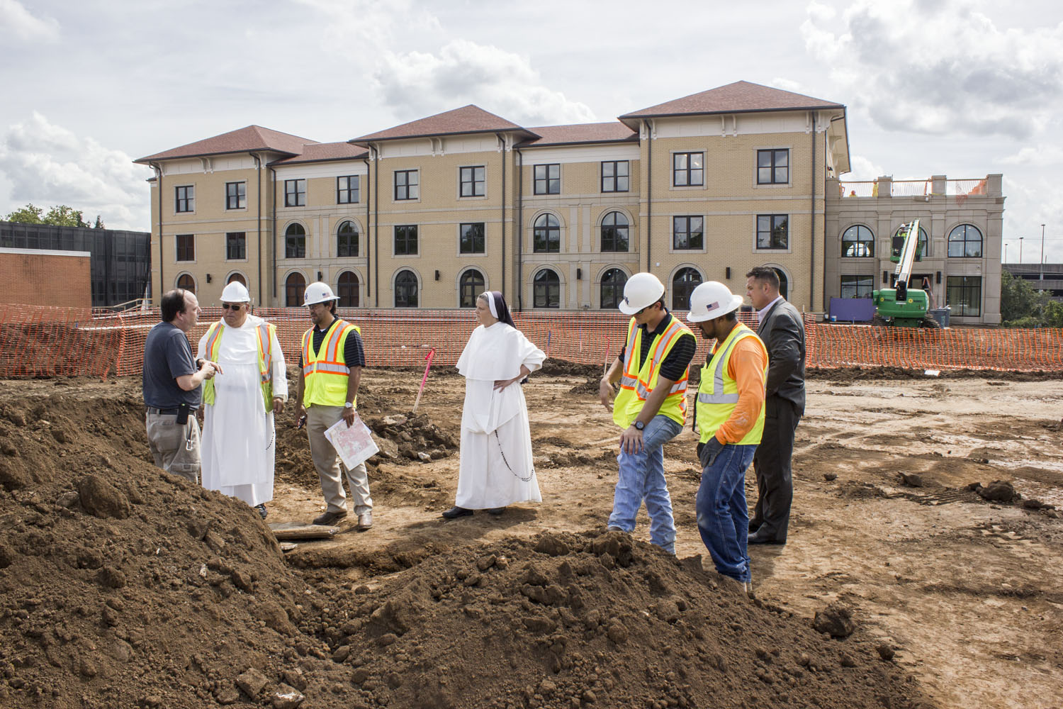 Ben Nance, archaeologist with the State of Tennessee, consults with Aquinas College adminsitration and construction crews at the site where the tombstones were uncovered