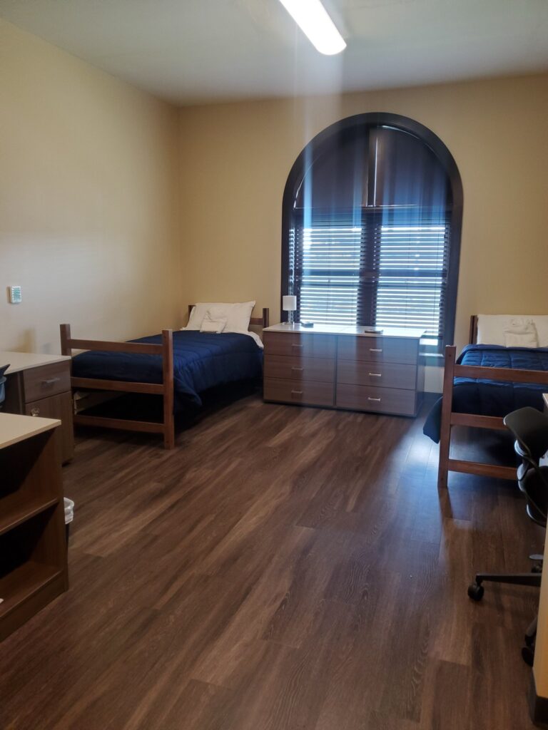 Siena Hall Conference Center houses fifty spacious bedrooms each with twin beds, two desks with chairs, two dressers, storage cabinets, linens, towels, and in-room thermostat-controlled AC/heat. 