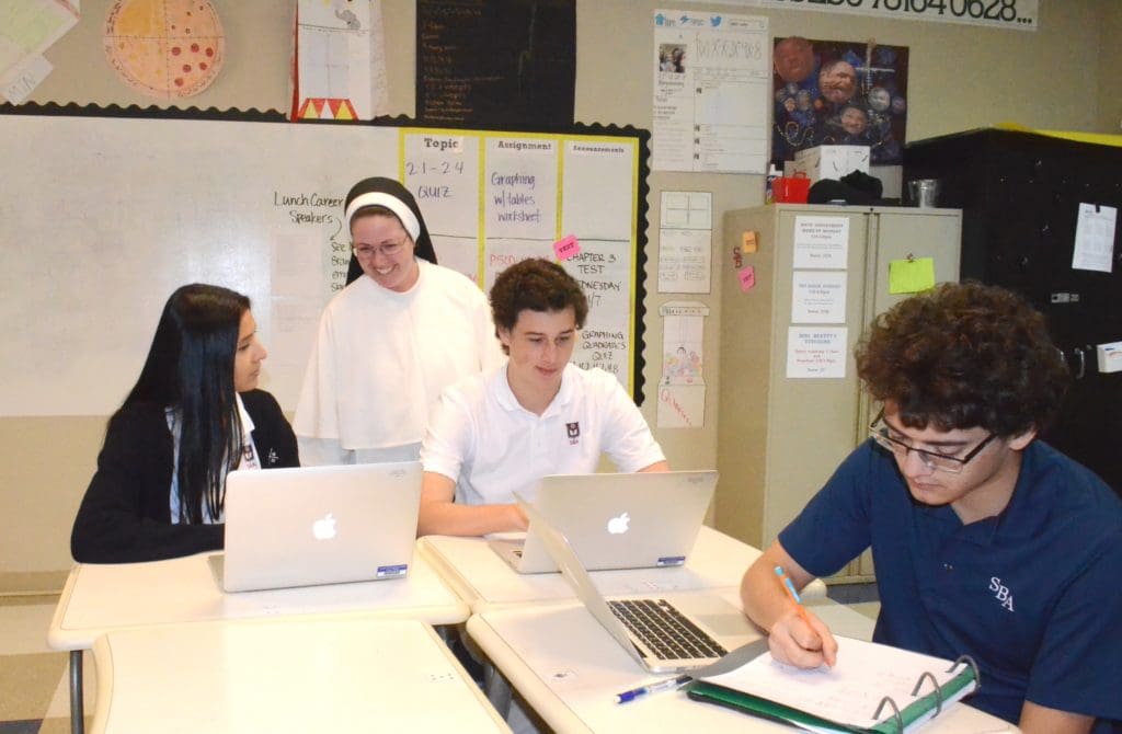 Sister Margaret Joseph Ference, O.P., '19, an M.A.T. candidate, pictured during Math class with students at St. Benedict at Auburndale in Memphis.