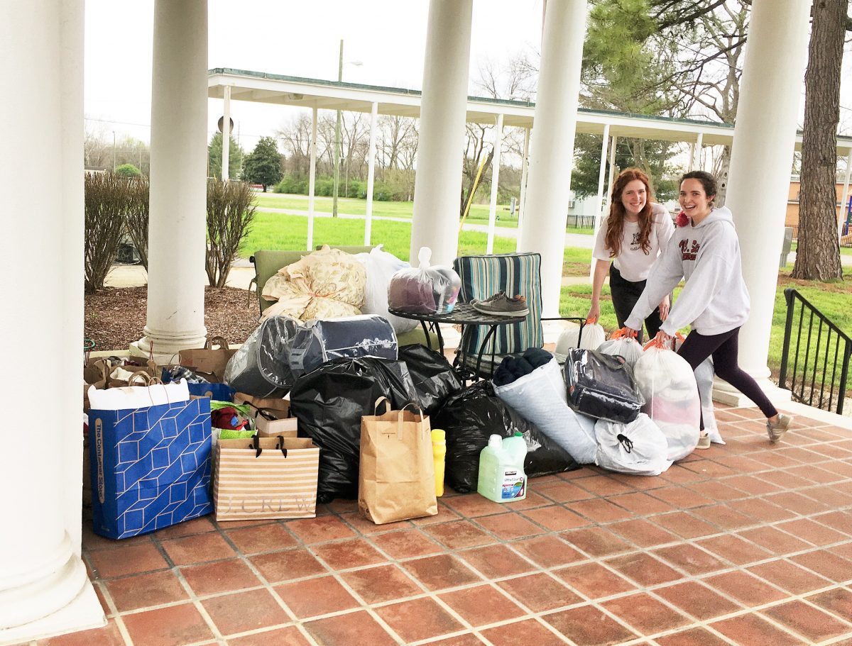Logan Kemp, an alumna of St. Cecilia Academy and her sister, Kate, a current student at SCA, deliver donations to The Dominican Campus White House on Sunday to help homeless persons suffering from COVID-19.