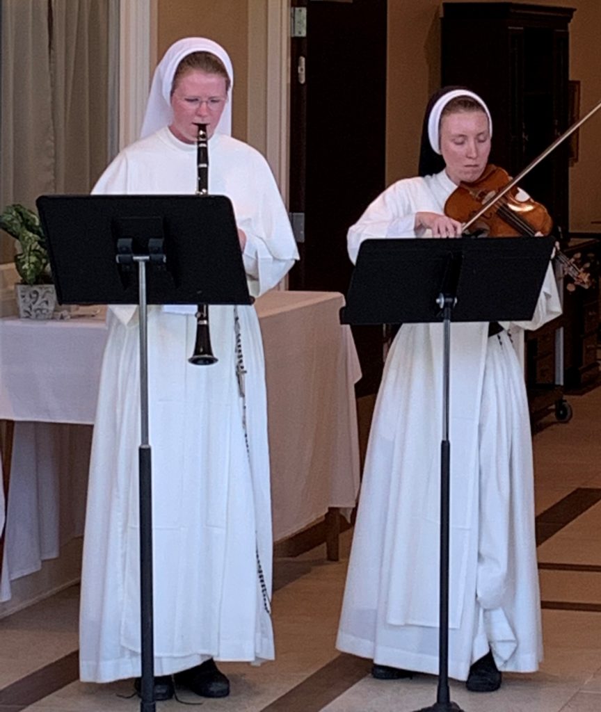 Aquinas Students Sister Elizabeth Grace and Sister Agnes Rose provide a musical selection during Aquinas’ Scholarship Brunch in Fall, 2021