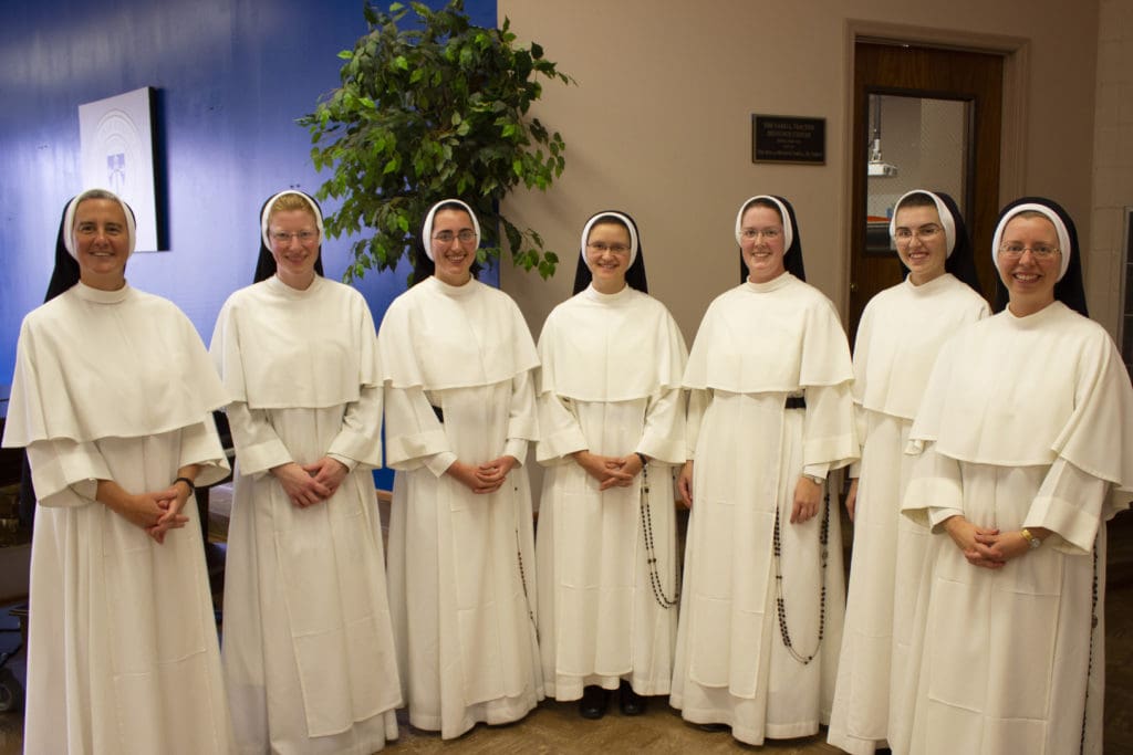 Sister Mary Rachel Capets, O.P., '00, Interim Dean of the School of Education, left, and Sister Mary Agnes Greiffendorf, O.P., '02, President, right, with inductees to the Aquinas College Teacher Education Program on October 31